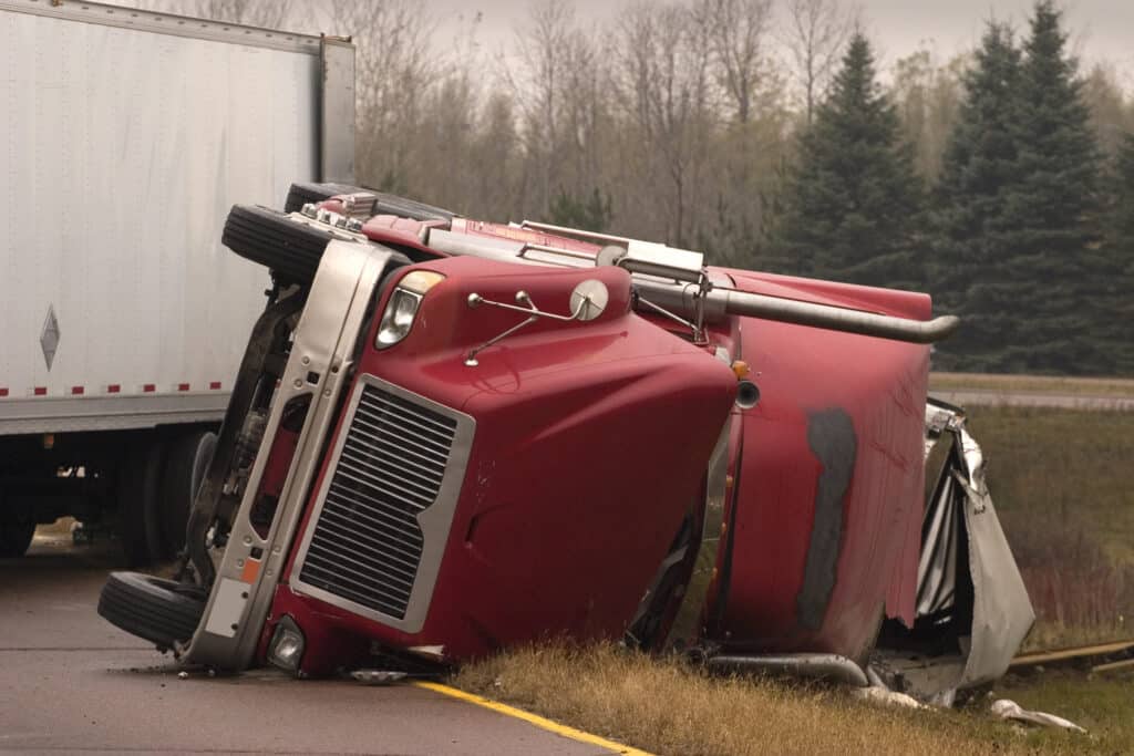 semi truck turned over after an accident with a car owner in need of understanding truck accident liability in south carolina